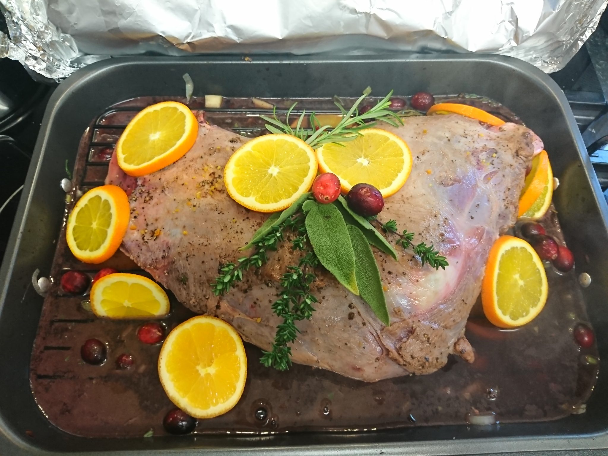 Venison prepared for roasting with cranberries, orange and thyme