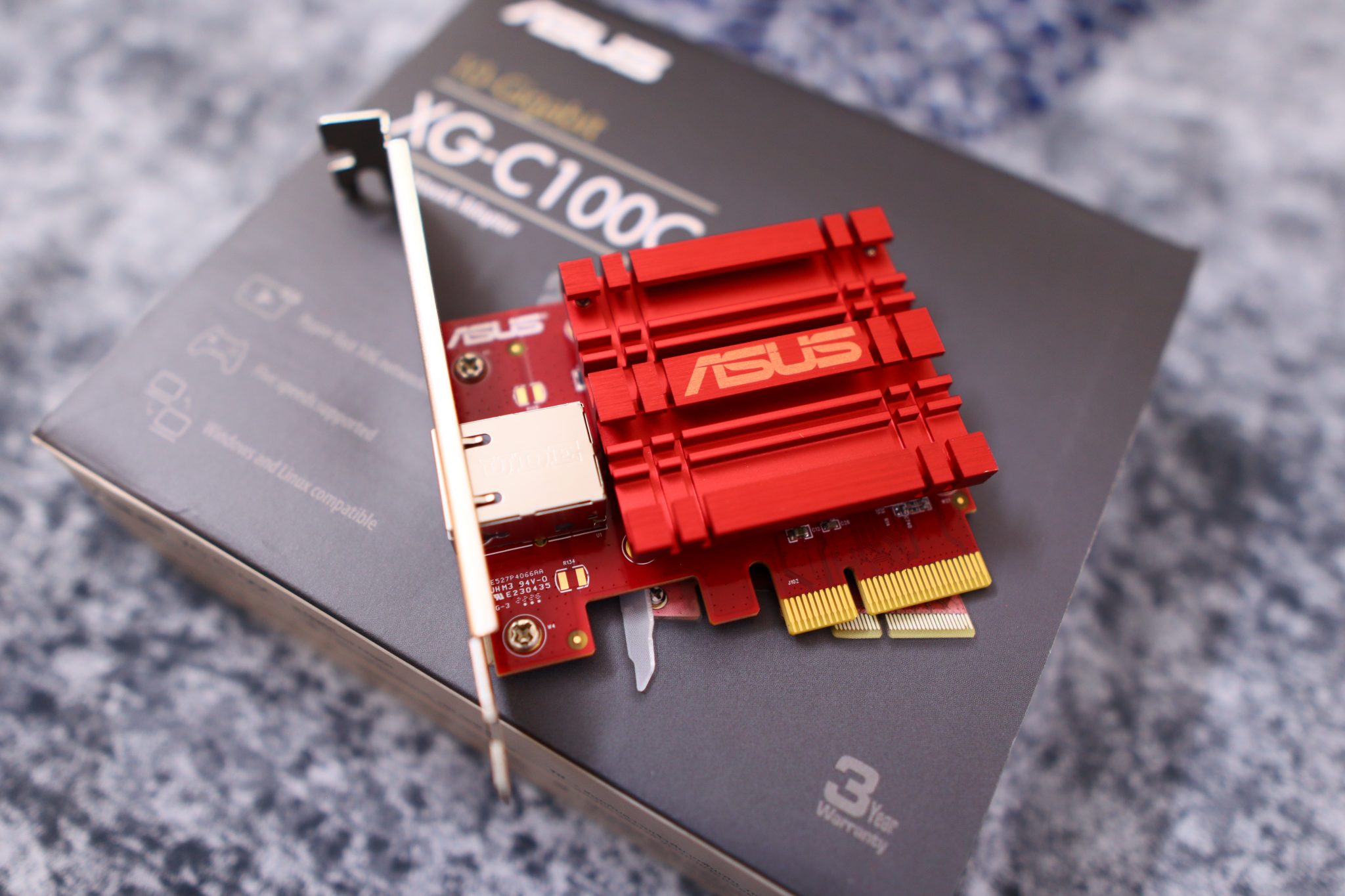 PCIe ASUS network card placed on top of its box