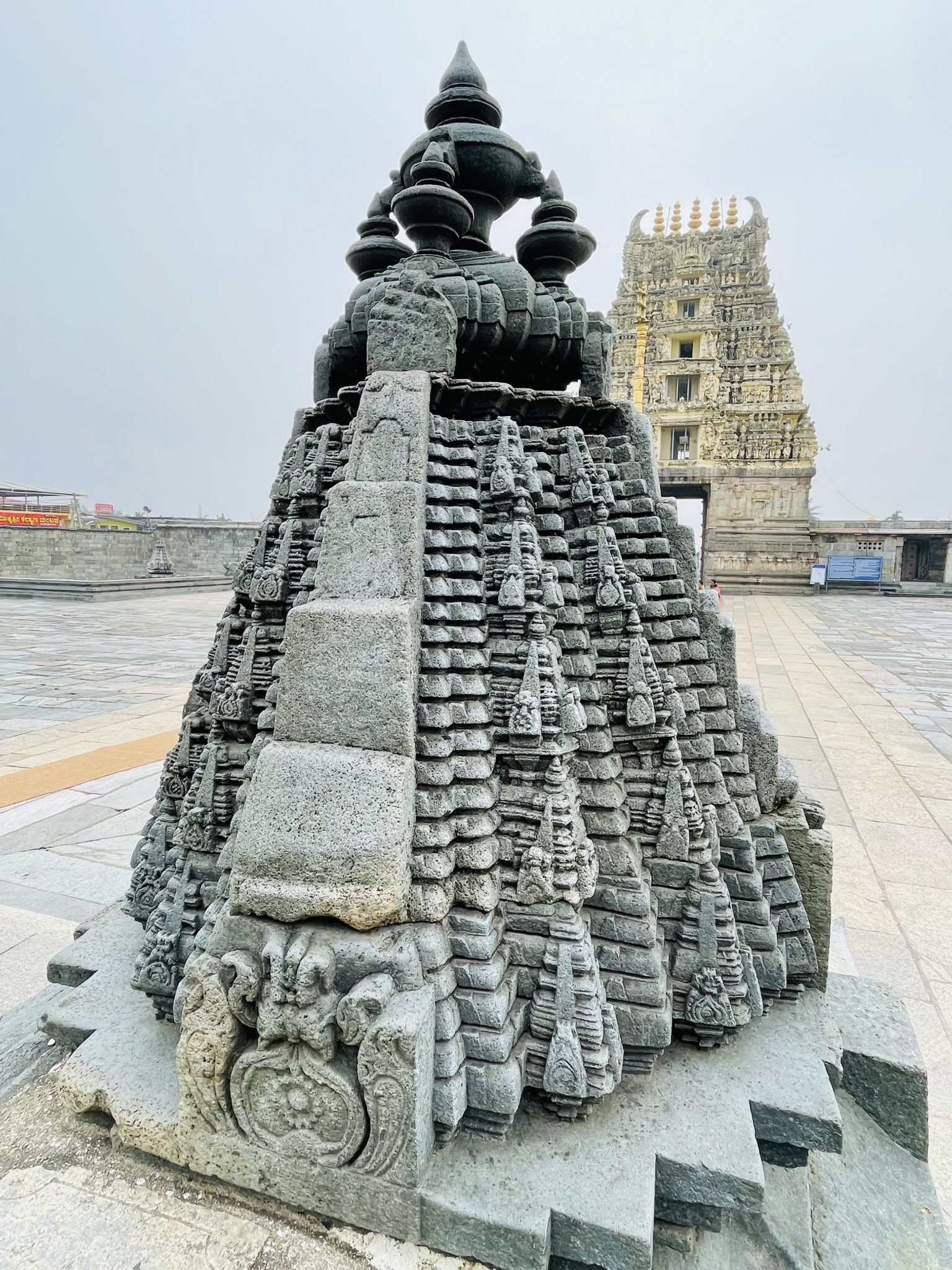 A miniature tower and main entrance tower(Gopuram) of Shri Chennakeshava Swami Temple. Belur, Karnataka, India. Smaller one is 800 years old and main tower is around 300 years old.