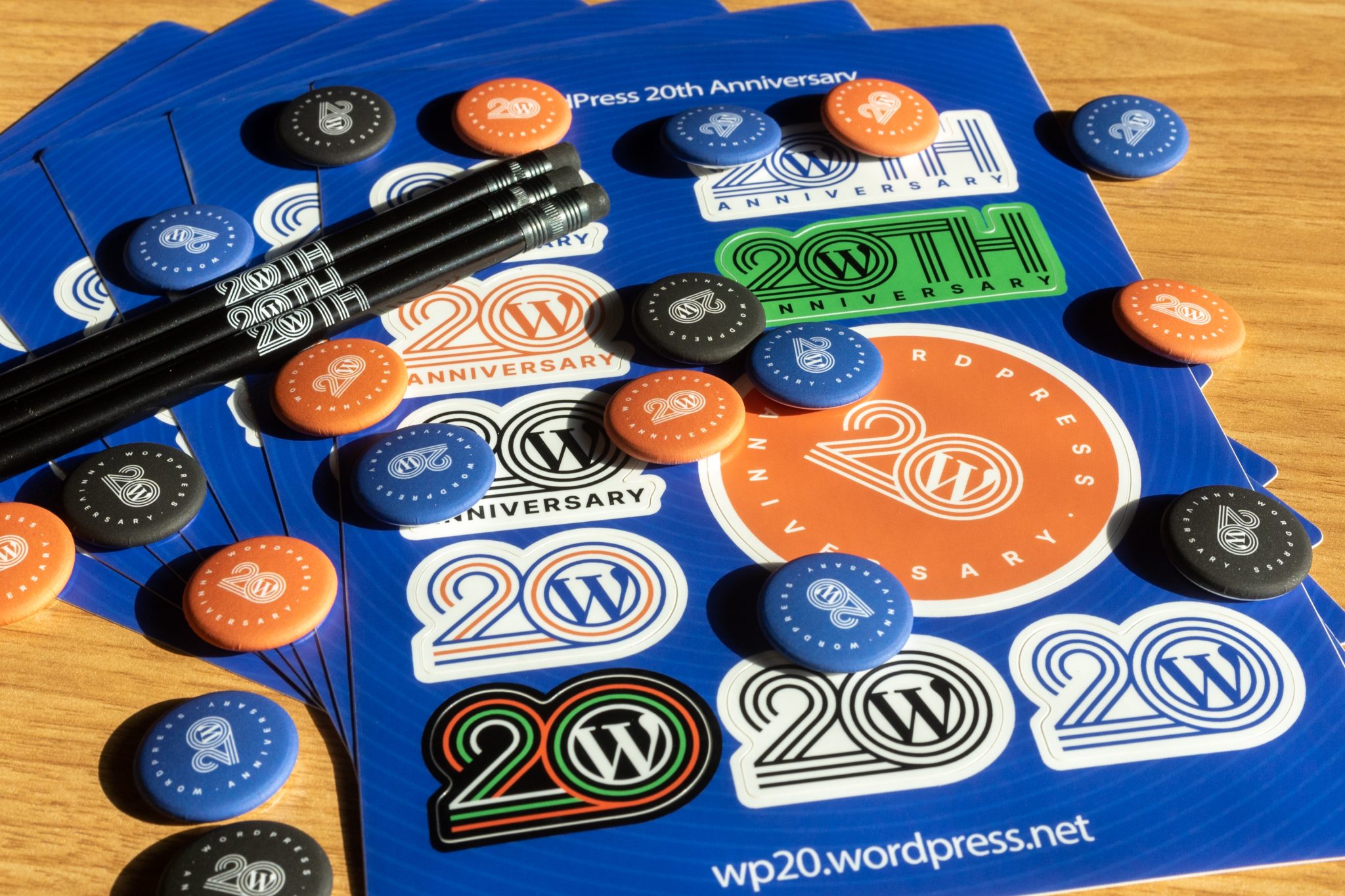 WP20 Swags for Meetups celebrating 20th Anniversary of WordPress. Includes stickers, pencil and 3 color variations of Pinback Buttons.