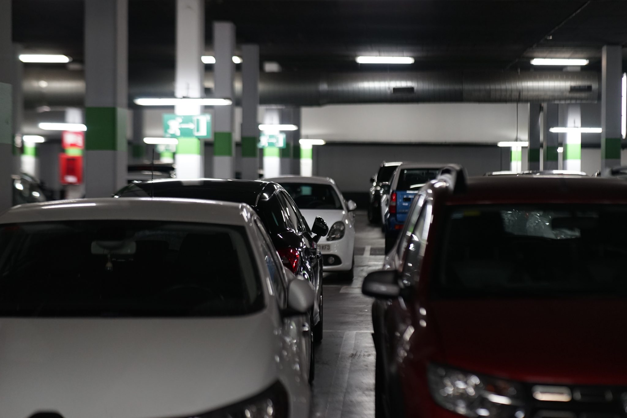 Cars at a parking. tags: car, garage, parking, transportation, indoors