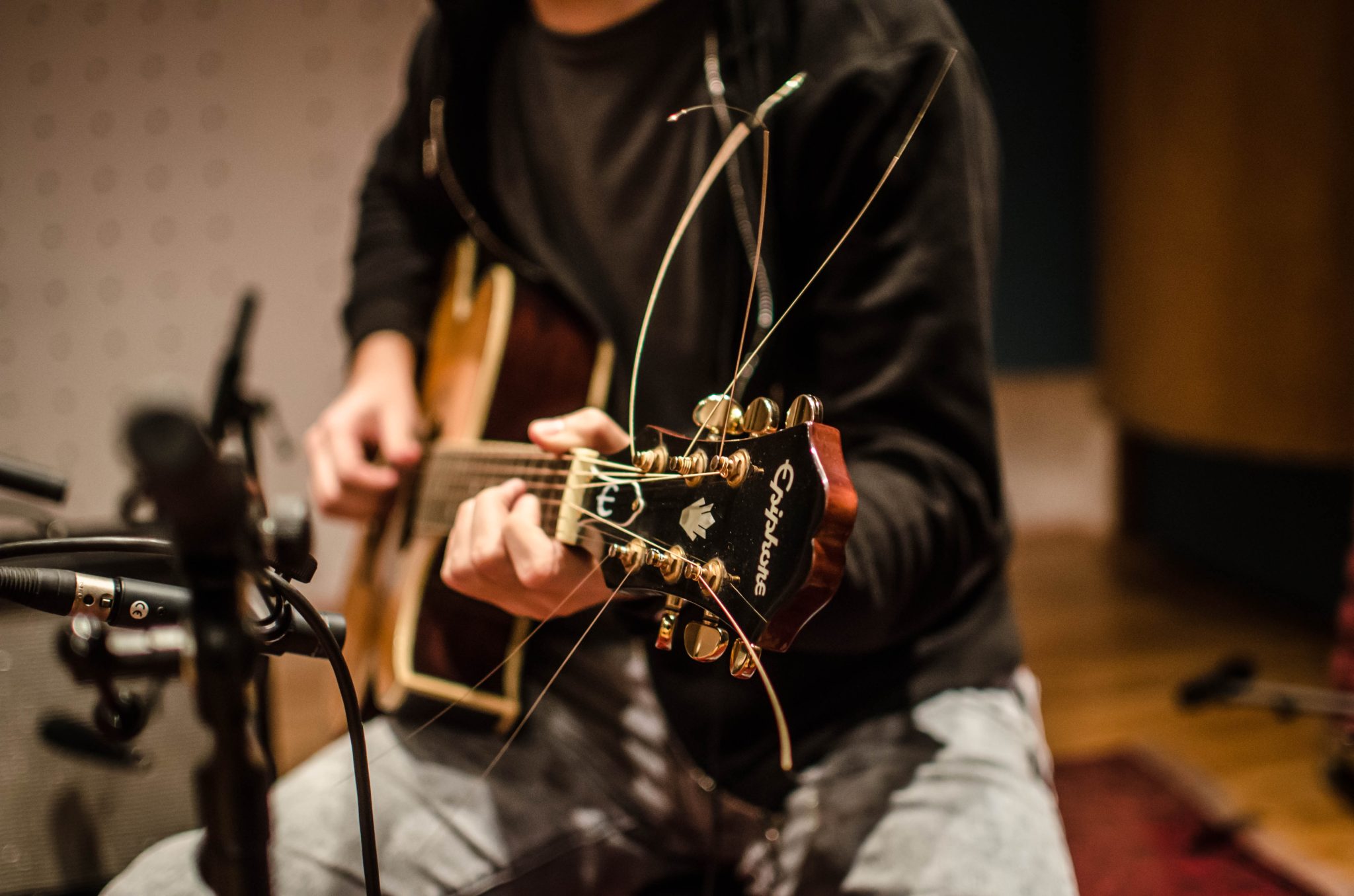 Photo of a recording session of an acoustic Epihone guitar