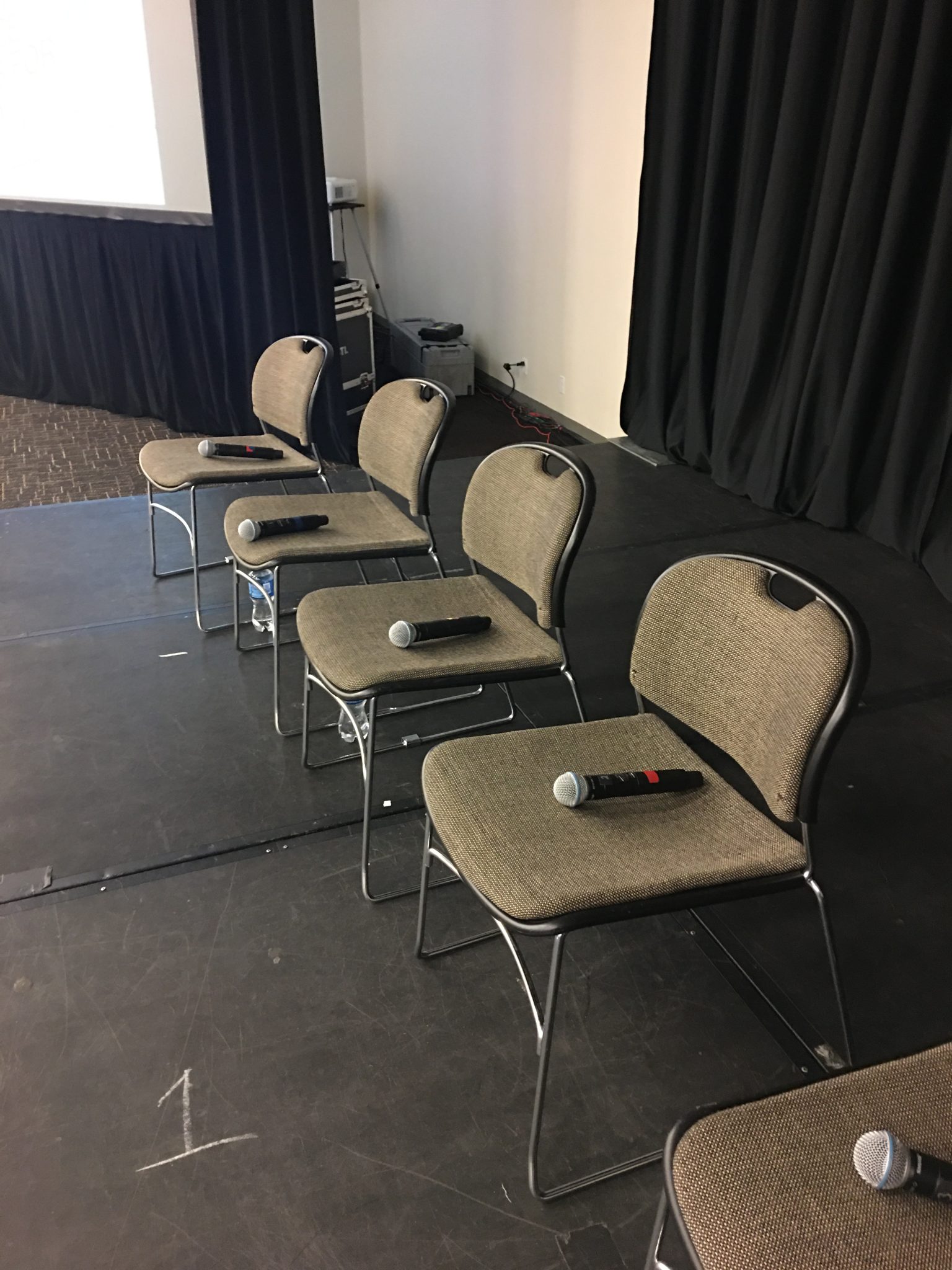 Microphones laid out on chairs, ready for a panel at WordCamp US 2019
