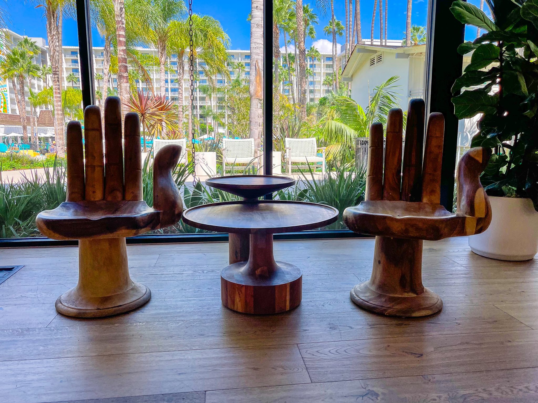 Unique hand chairs with hotel in the background