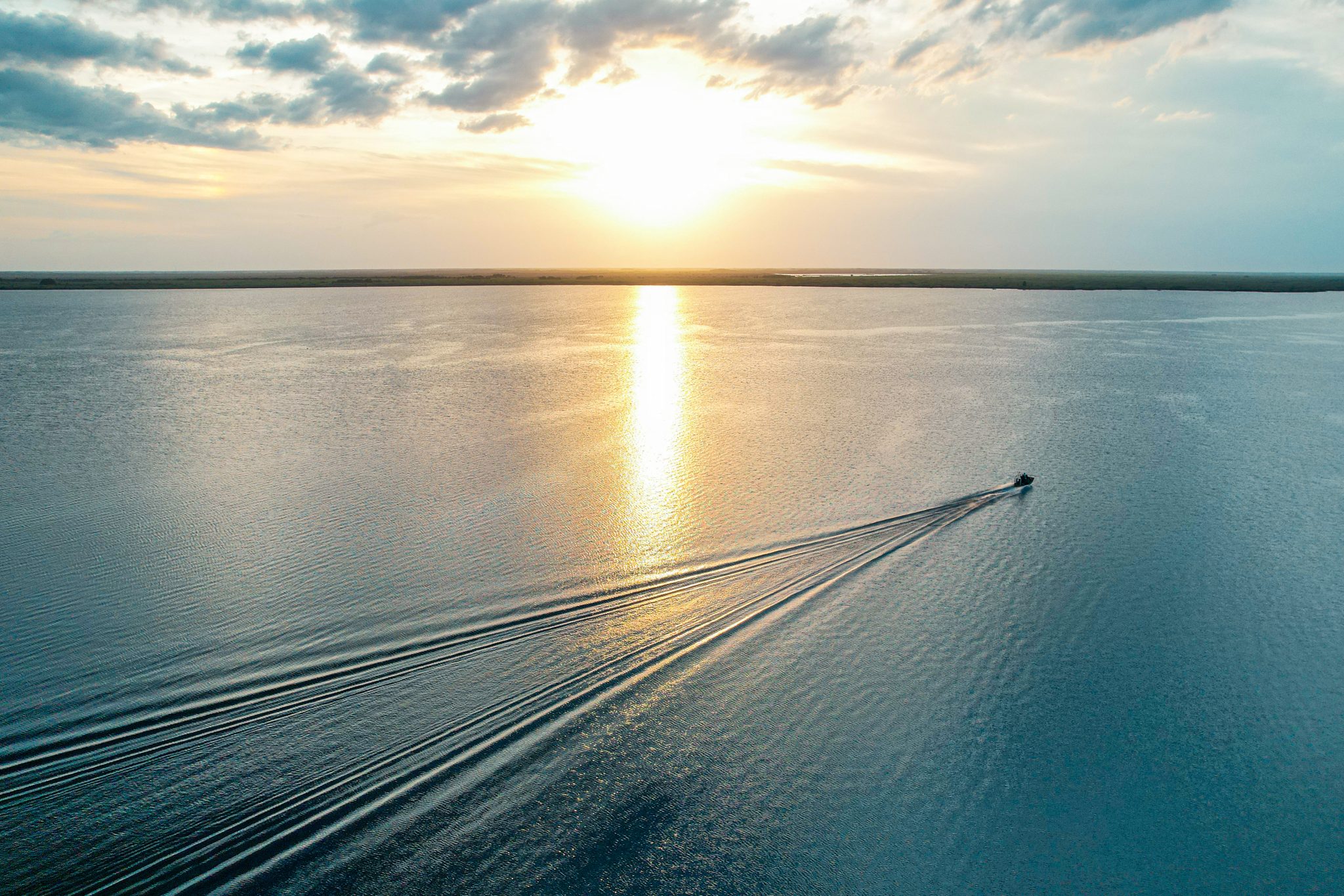 Airboat on a lake at sunset