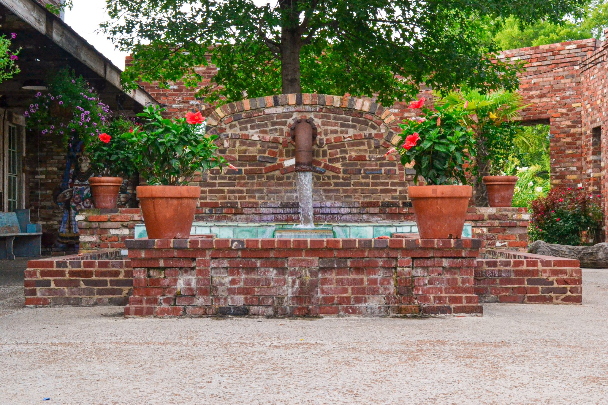 Mexican-style brick fountain with potted flowers