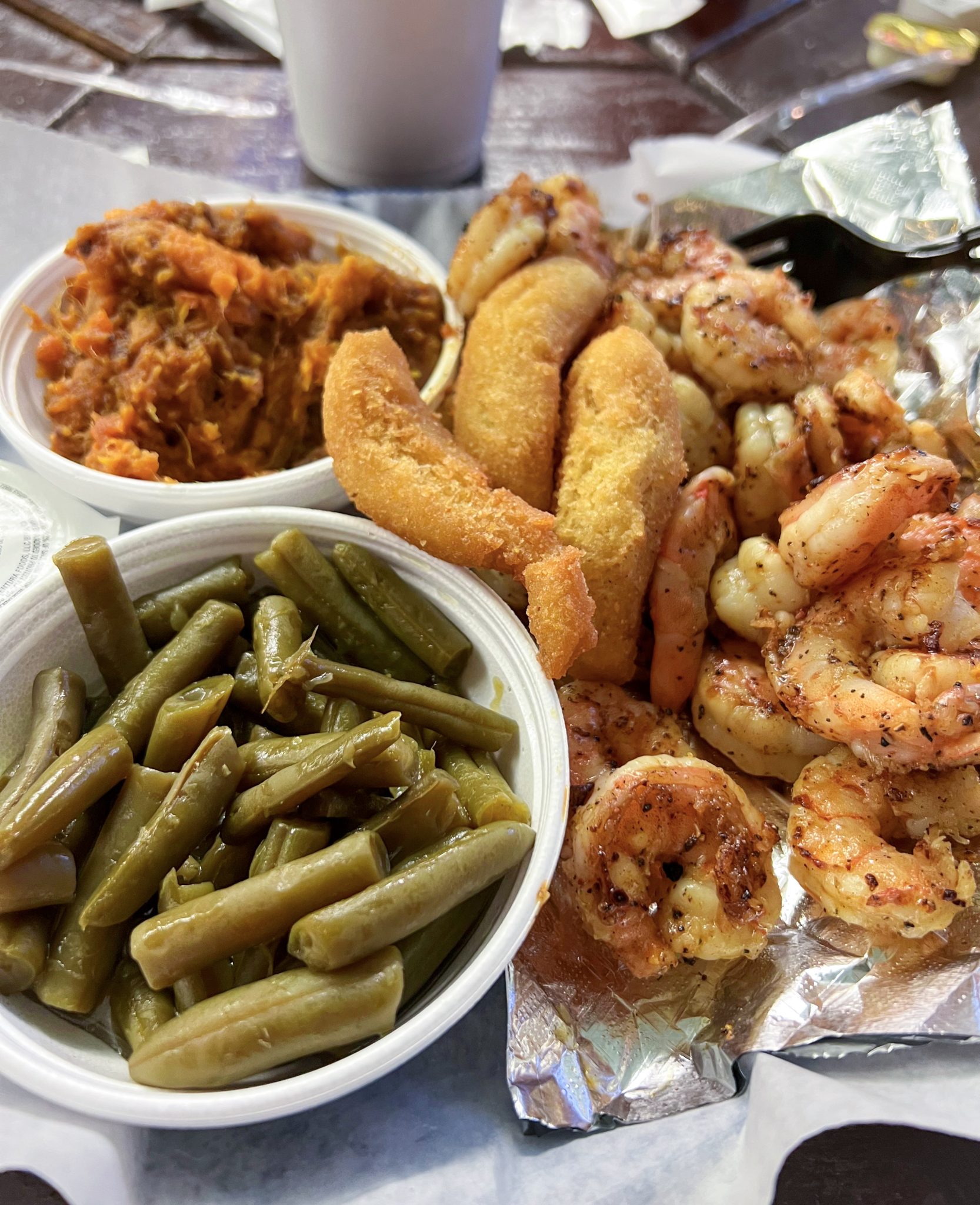 Grilled shrimp, green beans, sweet potato casserole, and hush puppies