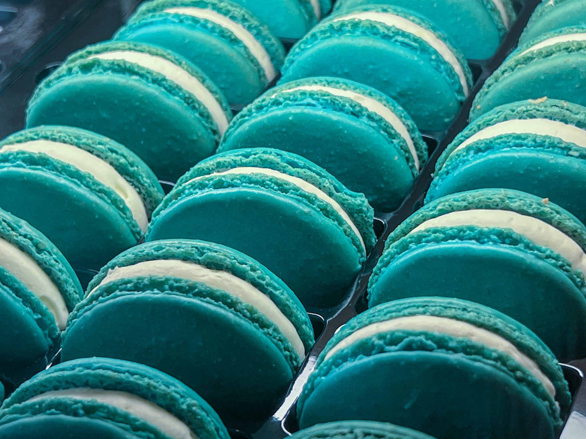 Three rows of teal macarons