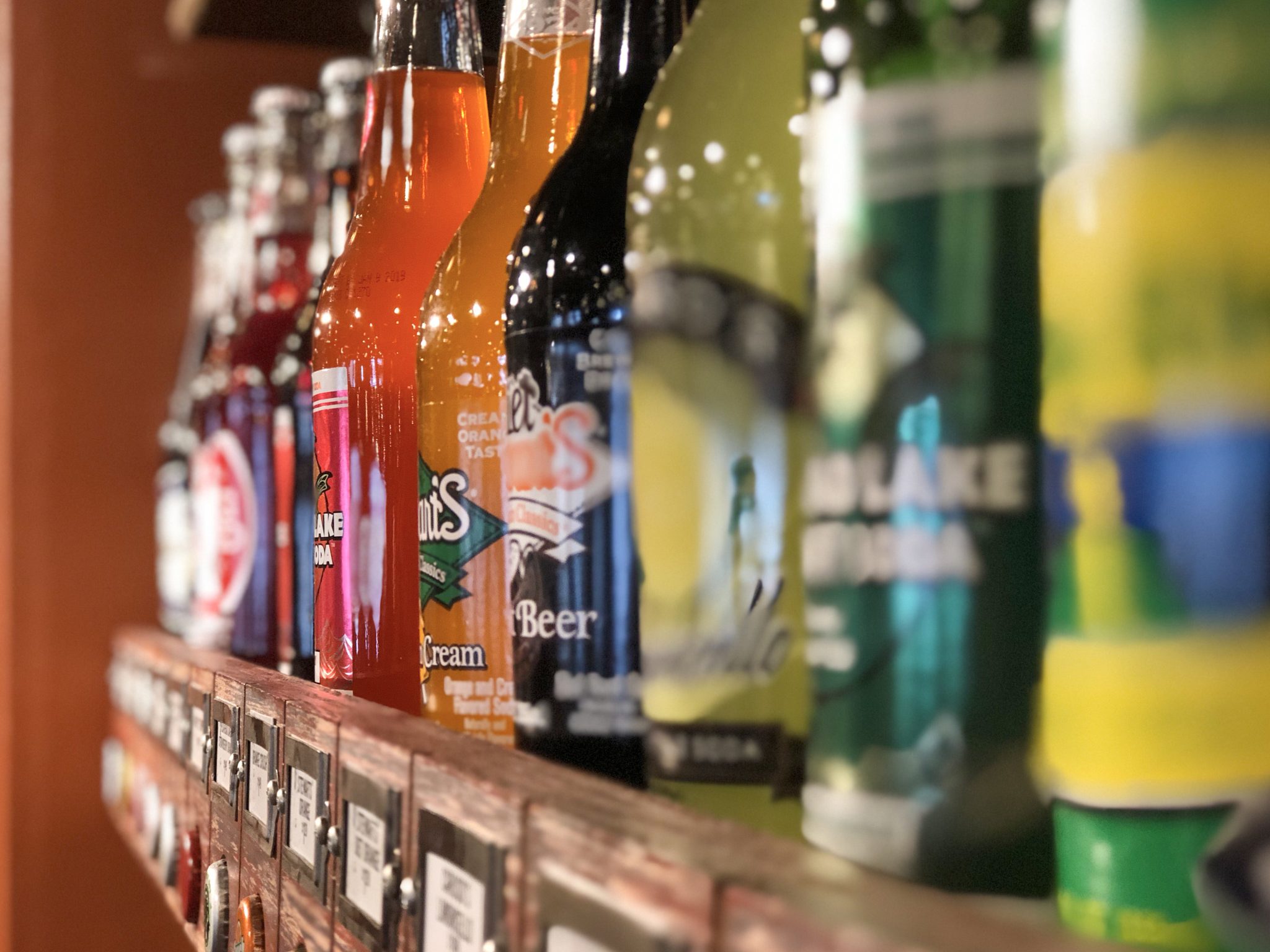 Row of classic soda bottles on a shelf