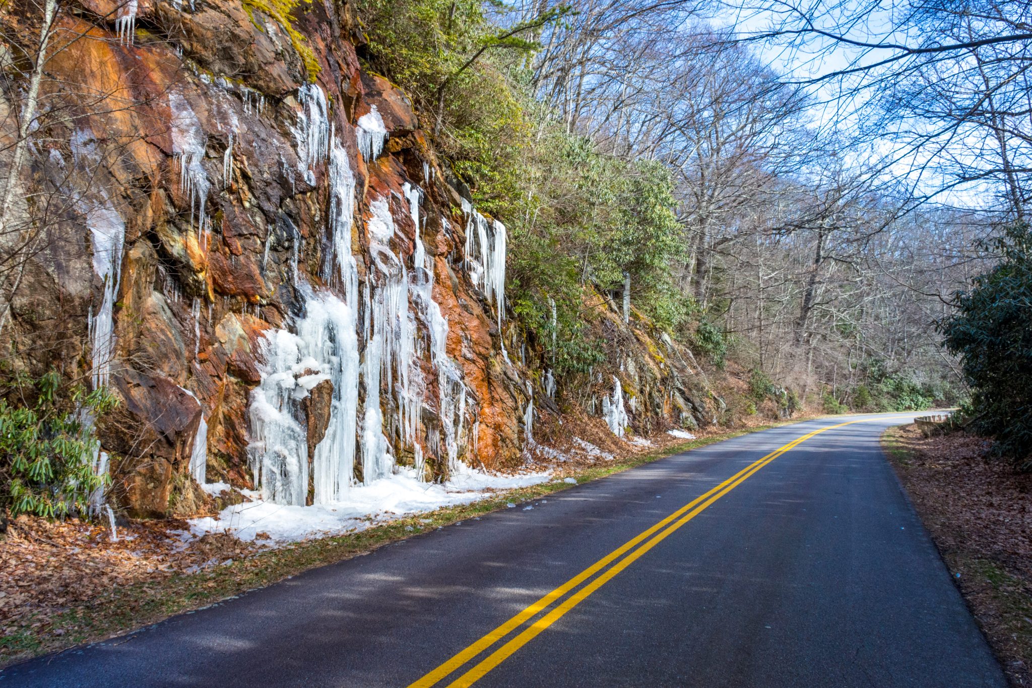 Icy water runoff on the side of a road
