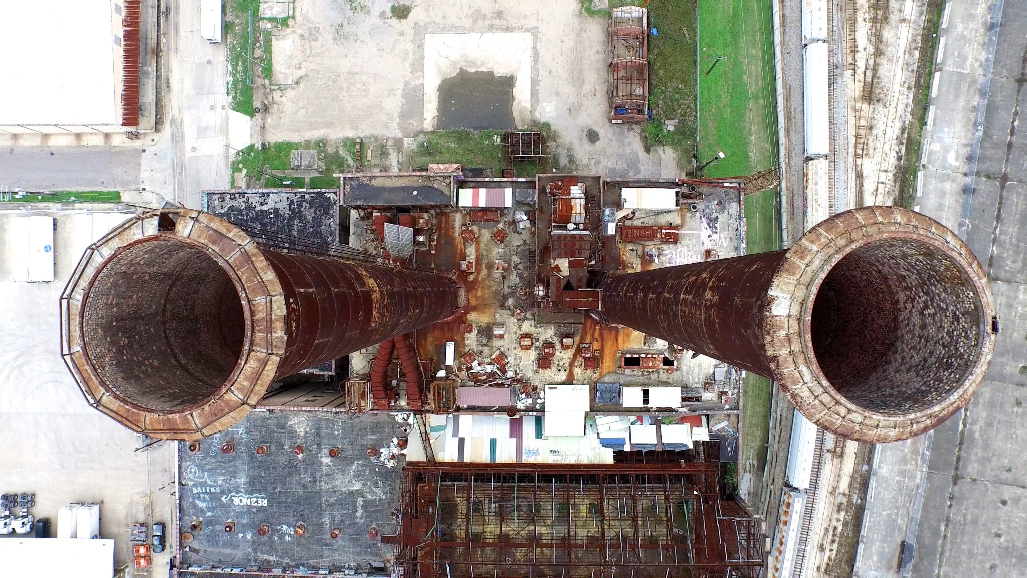 Looking down at two disused power station chimneys. Aerial drone footage.