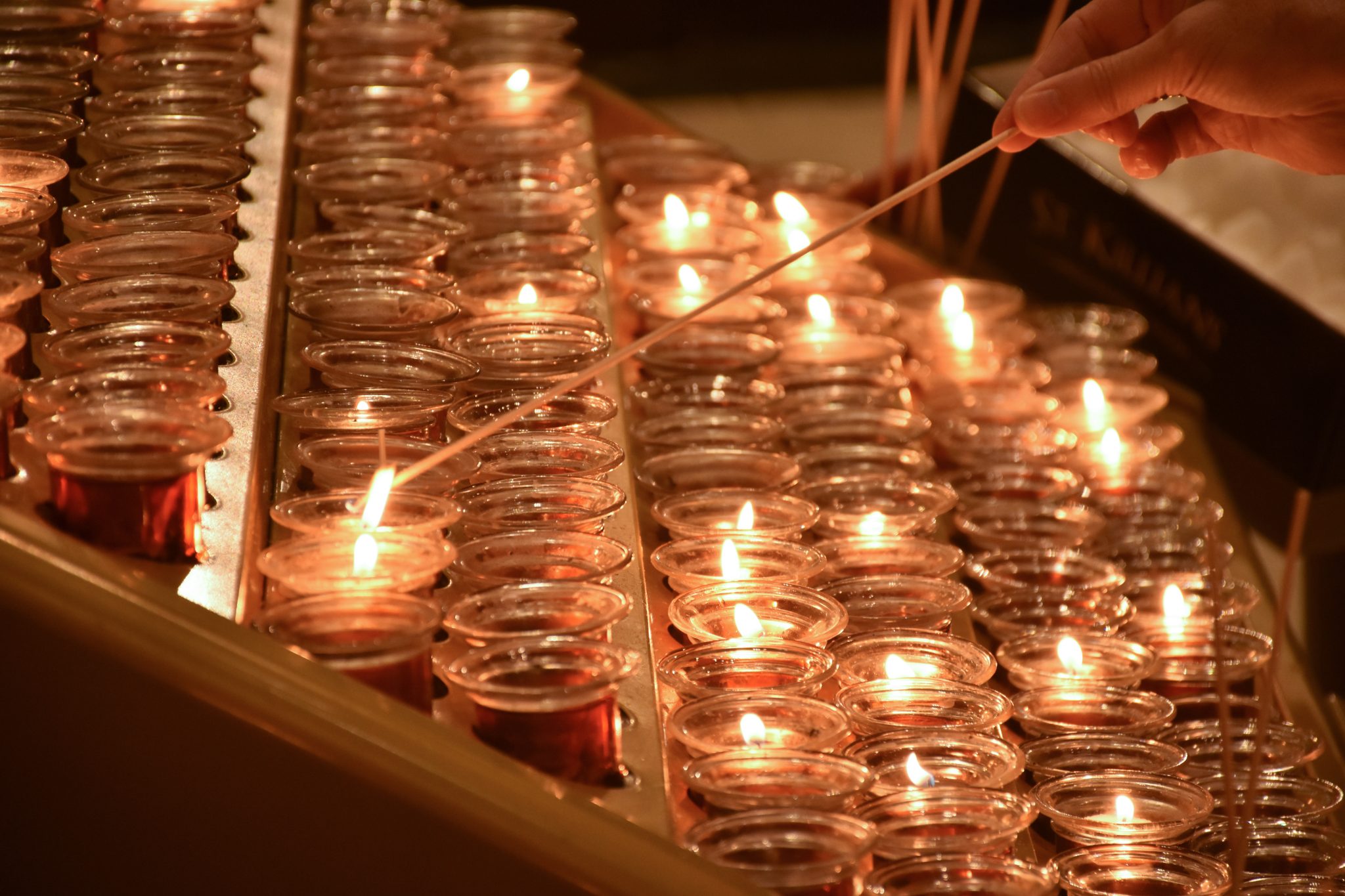 Rows of candles being lit