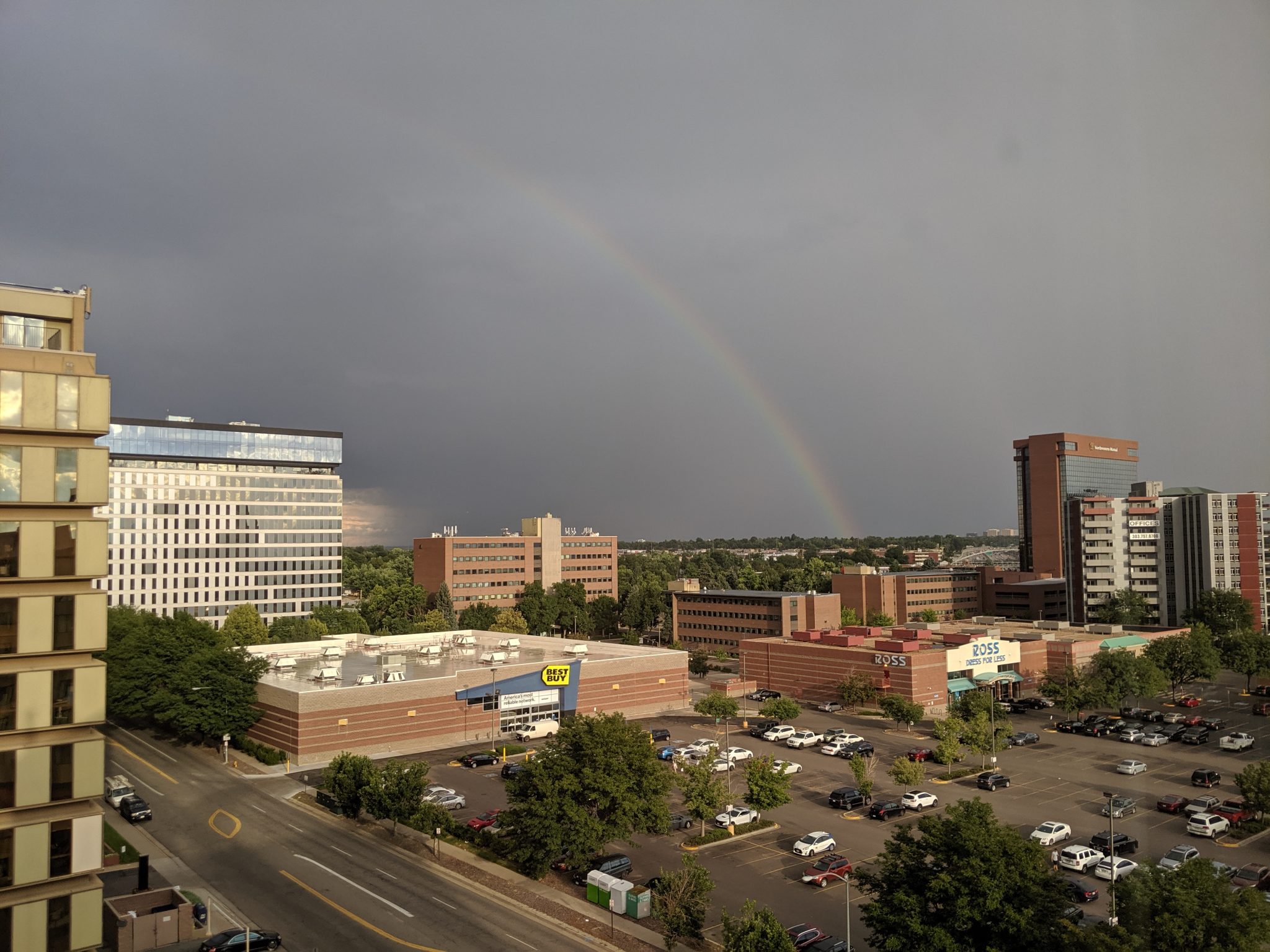 Rainbow over a city against a stormy sky