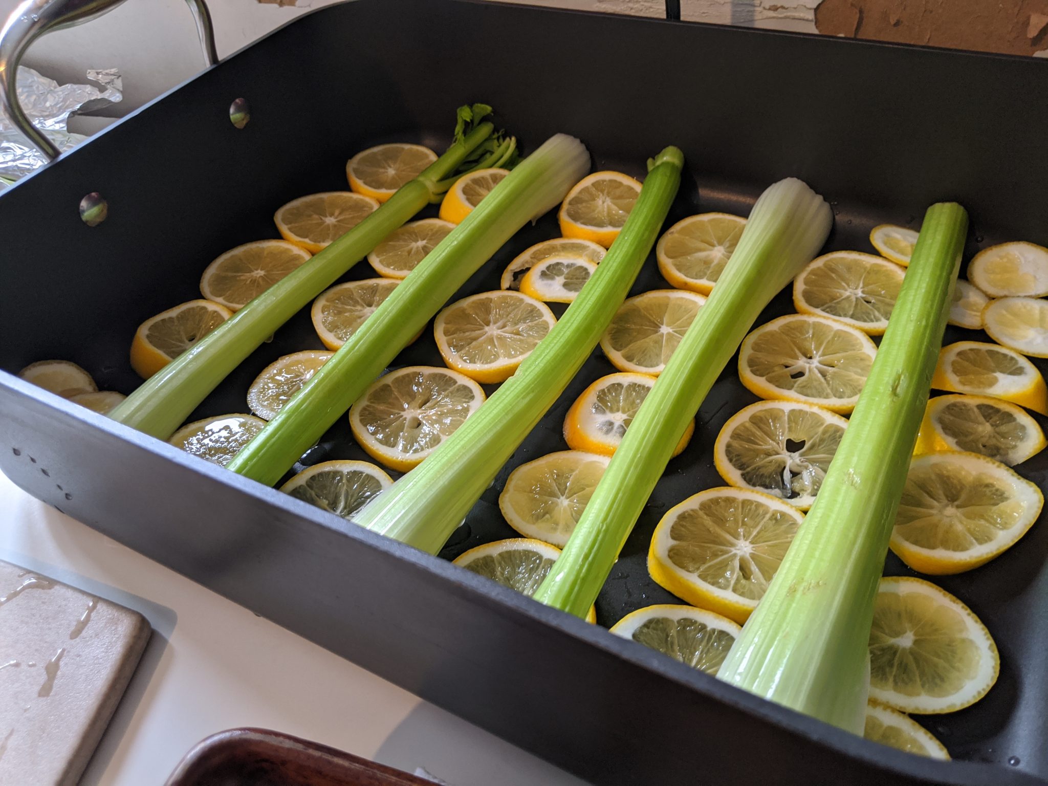 Lemons and celery laid out in a pan