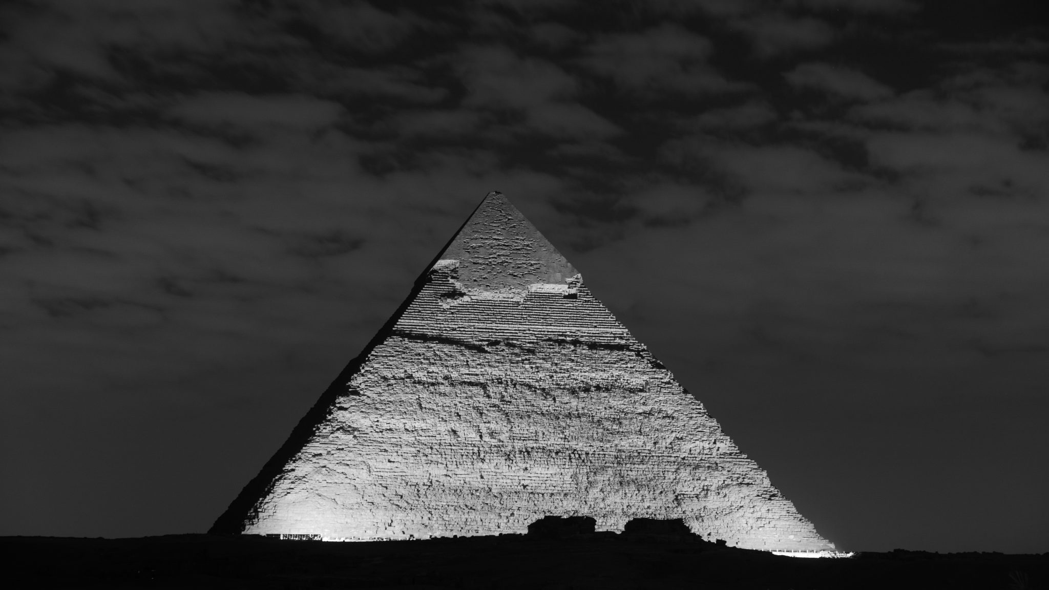 The Great Pyramid of Giza lit up at night.