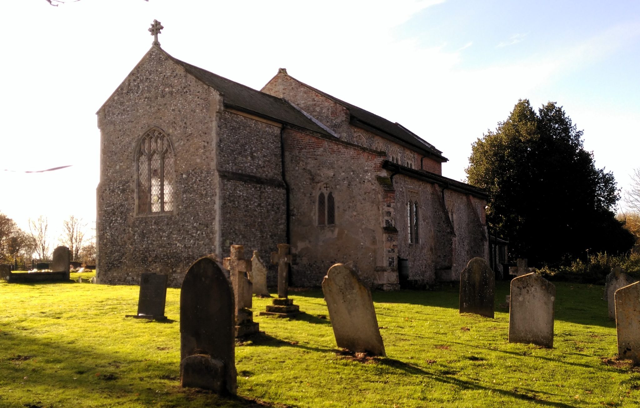 Norfolk Church yard with gravestones in the foreground