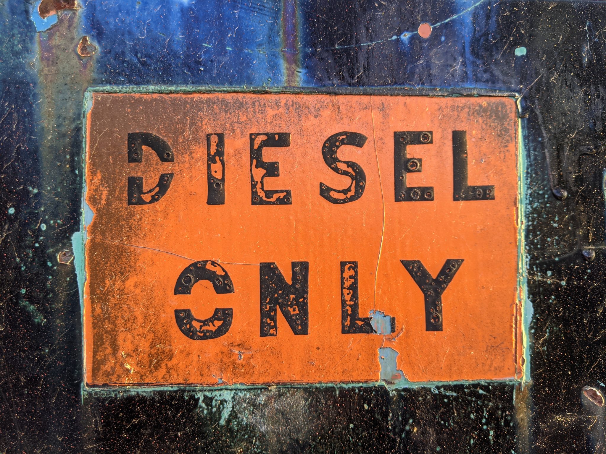 Old corroded sign that says "DIESEL ONLY"