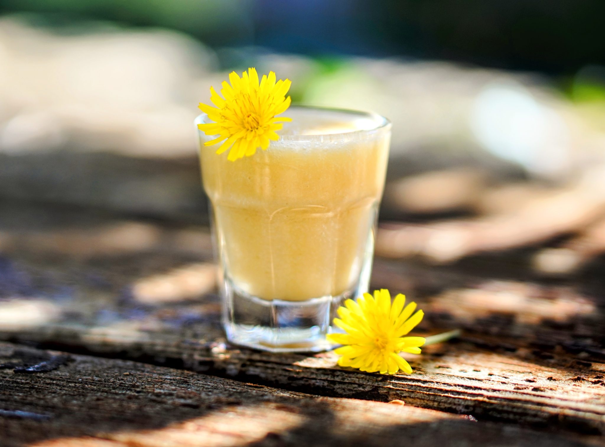 Yellow juice adorned with a yellow flower.