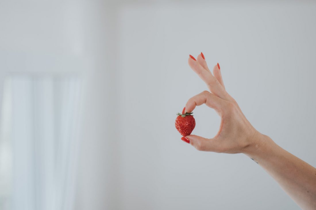 Woman Holding a Strawberry
