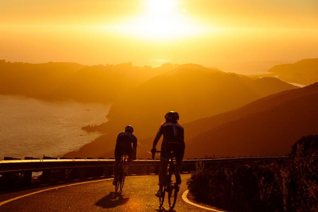 Men Cycling at Sunset