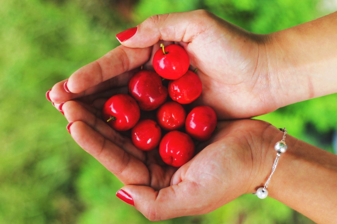 Woman Holding Cherries