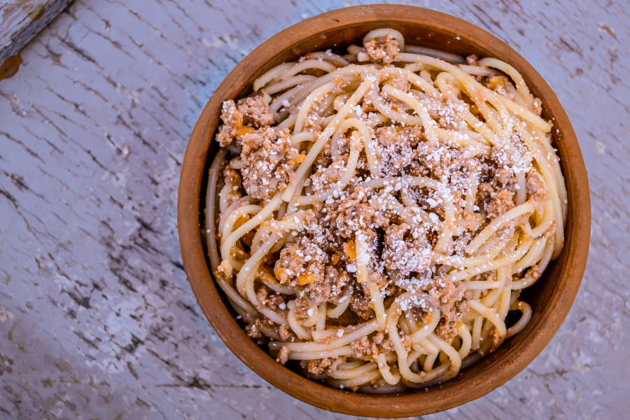 Bowl of Spaghetti with Minced Meat on a Broken Paint Wooden Background