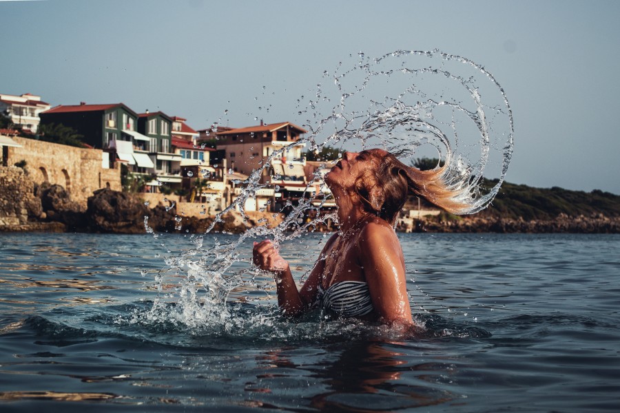 Girl Splashing Hair in the Sea with Mediterranean Background