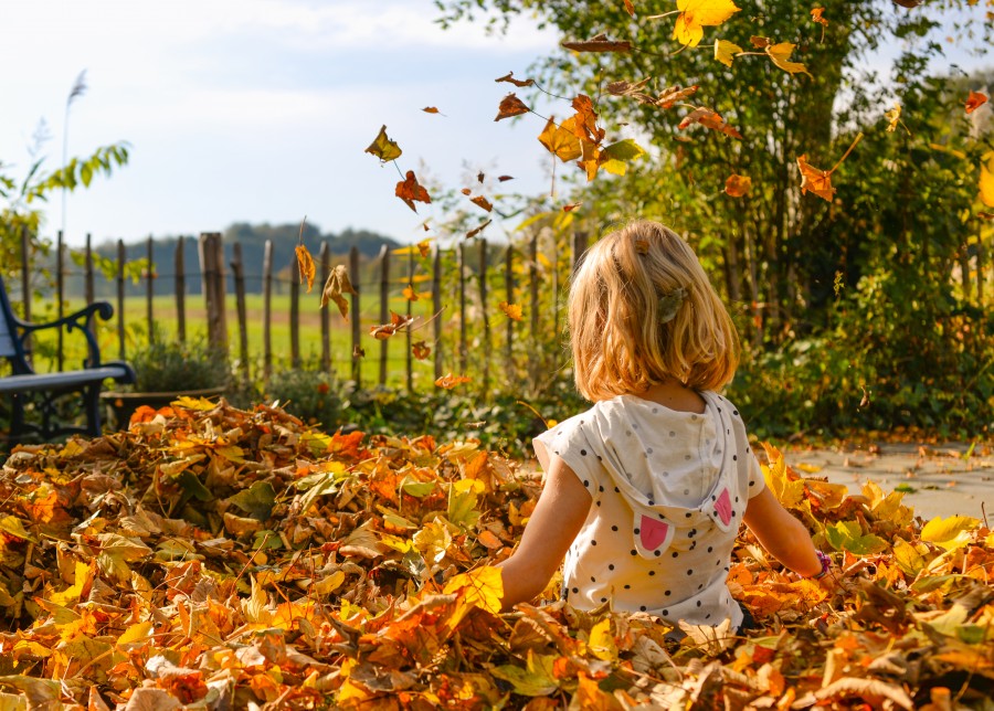 Girl playing with leaves