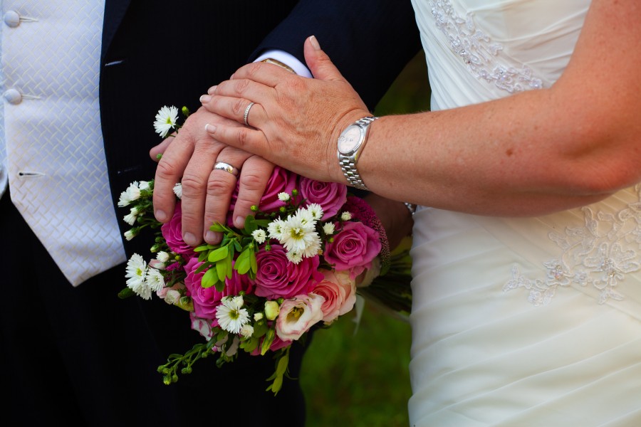 couple holding hands after being married