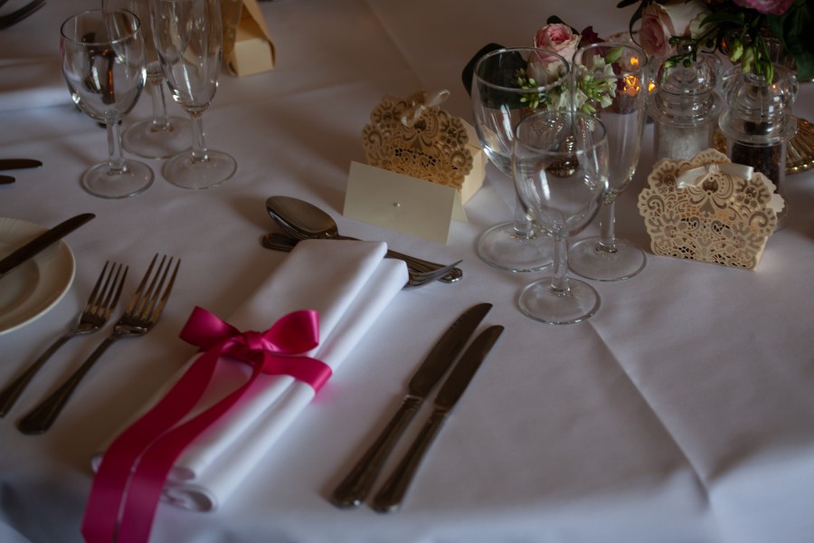 place setting with napkin and pink ribbon