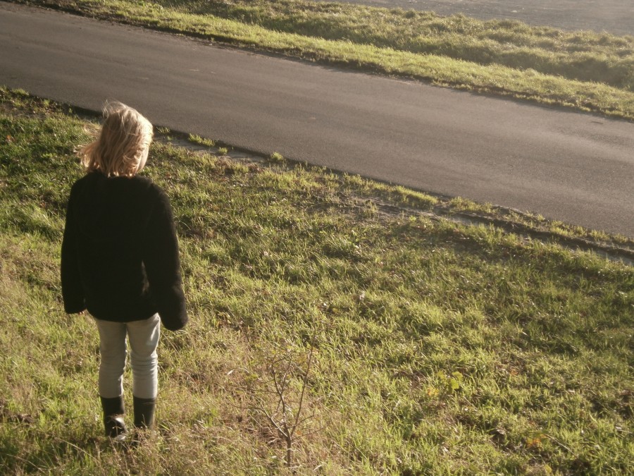 Girl standing near a road