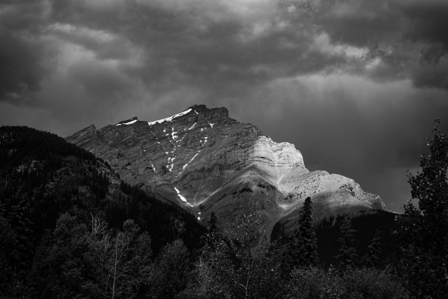 Black and white mountain with sun shining on it