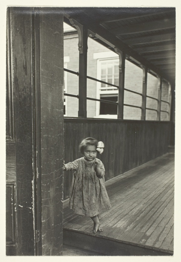 Little Girl Standing At Entrance To A Gallery